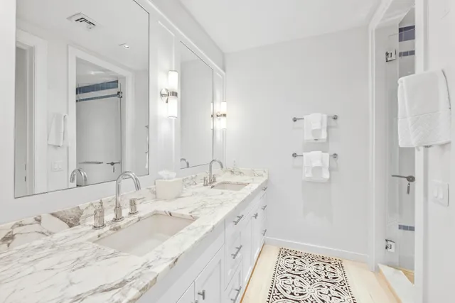 a bathroom with a granite countertop sink mirror and double