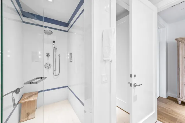 a bathroom with a tub shower and a sink