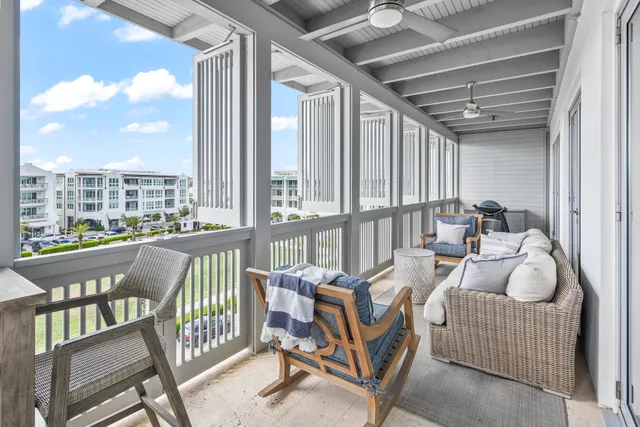 a living room with furniture and a floor to ceiling window
