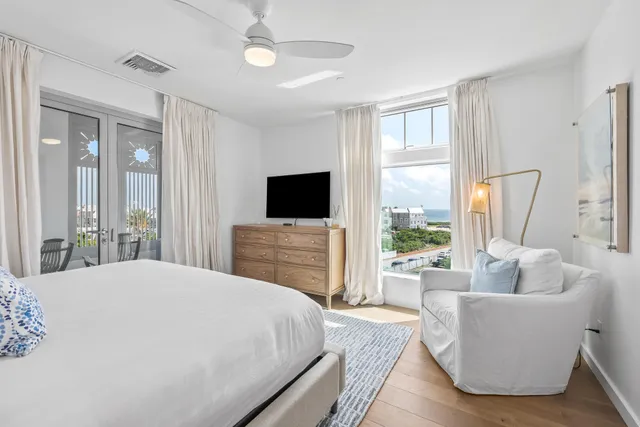 a spacious bedroom with a large bed and a flat screen tv