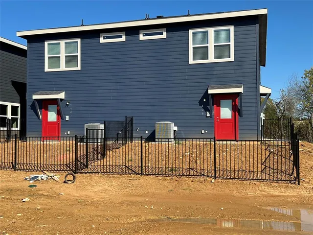 a view of a house with iron fence