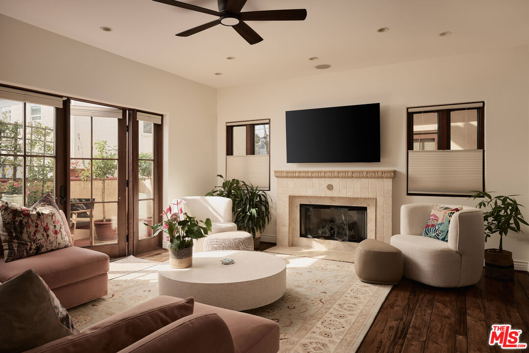 908 17th Street, Unit 8 Santa Monica, CA 90403 - Photo 3 of 15 a living room with furniture a fireplace and a flat screen tv