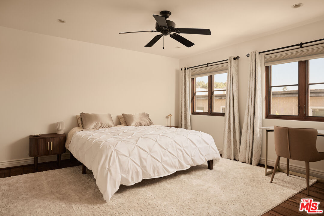 908 17th Street, Unit 8 Santa Monica, CA 90403 - Photo 8 of 15 a bedroom with a bed and a chandelier