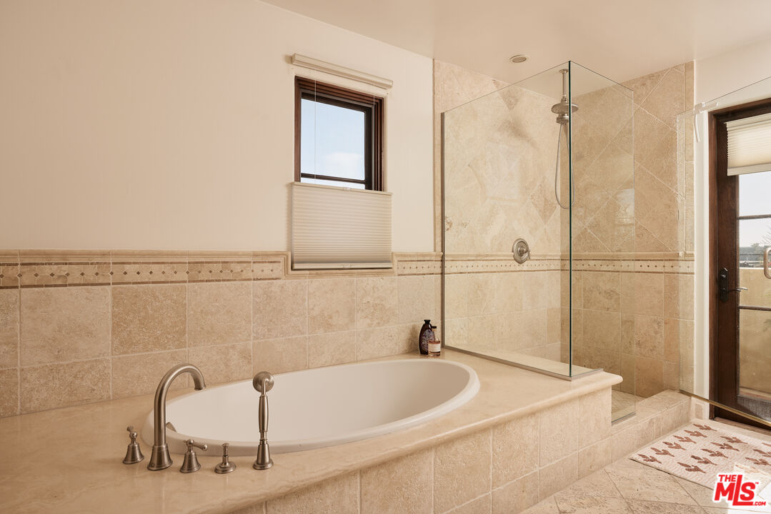 908 17th Street, Unit 8 Santa Monica, CA 90403 - Photo 10 of 15 a bathroom with a tub and a shower