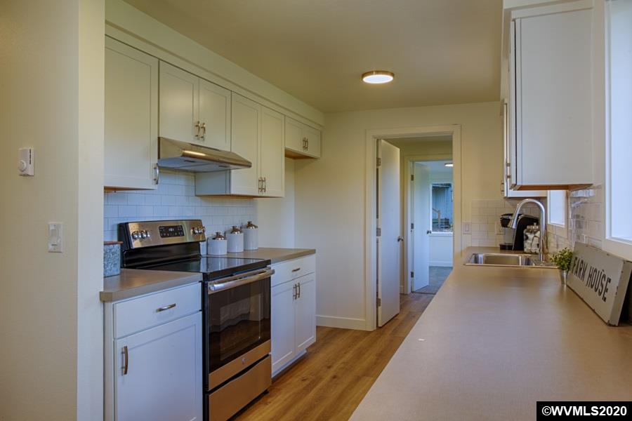 3245 Mistletoe Road Dallas, OR 97338 - Photo 14 of 28 a kitchen with stainless steel appliances granite countertop a stove a sink and a refrigerator