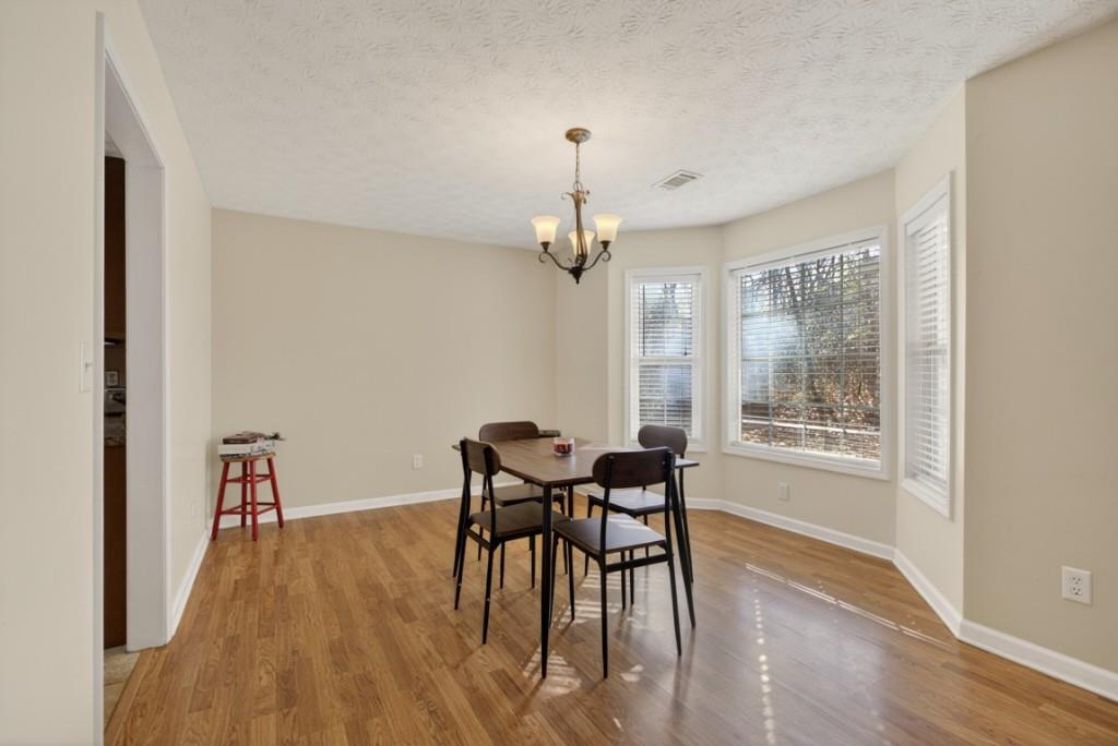 701 Muirfield Drive Winder, GA 30680 - Photo 11 of 35 a view of a dining room with furniture window and wooden floor