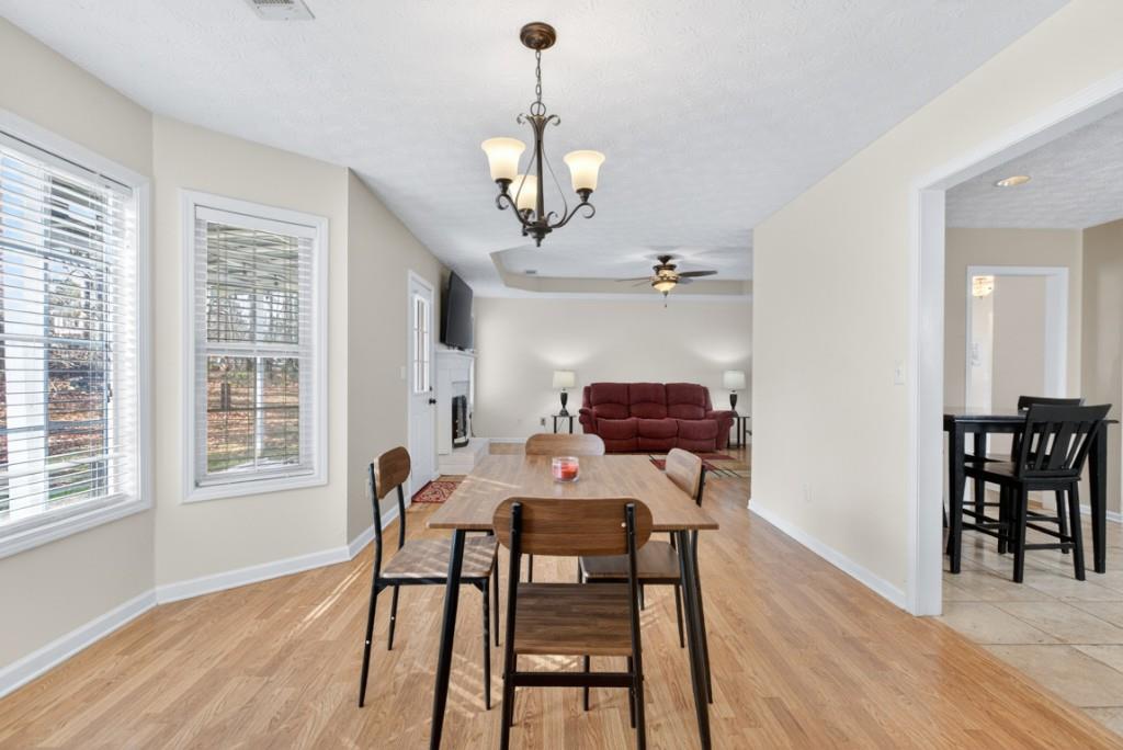 701 Muirfield Drive Winder, GA 30680 - Photo 13 of 35 a view of a dining room with furniture and wooden floor