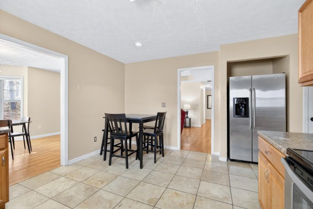 701 Muirfield Drive Winder, GA 30680 - Photo 19 of 35 a view of a kitchen and dining area a chandelier