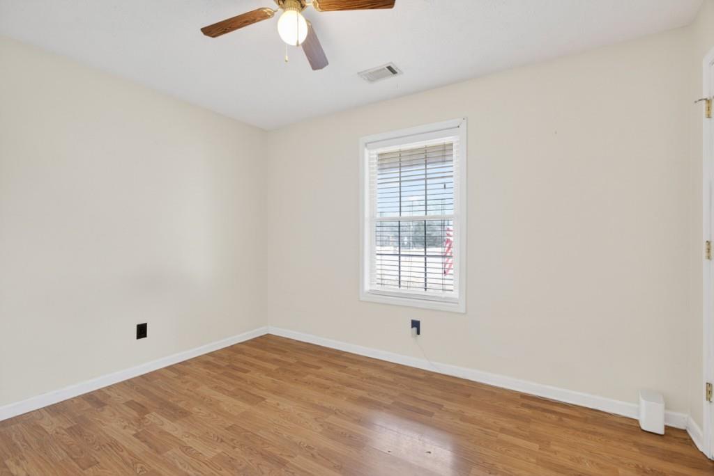 701 Muirfield Drive Winder, GA 30680 - Photo 23 of 35 an empty room with a window and a ceiling fan