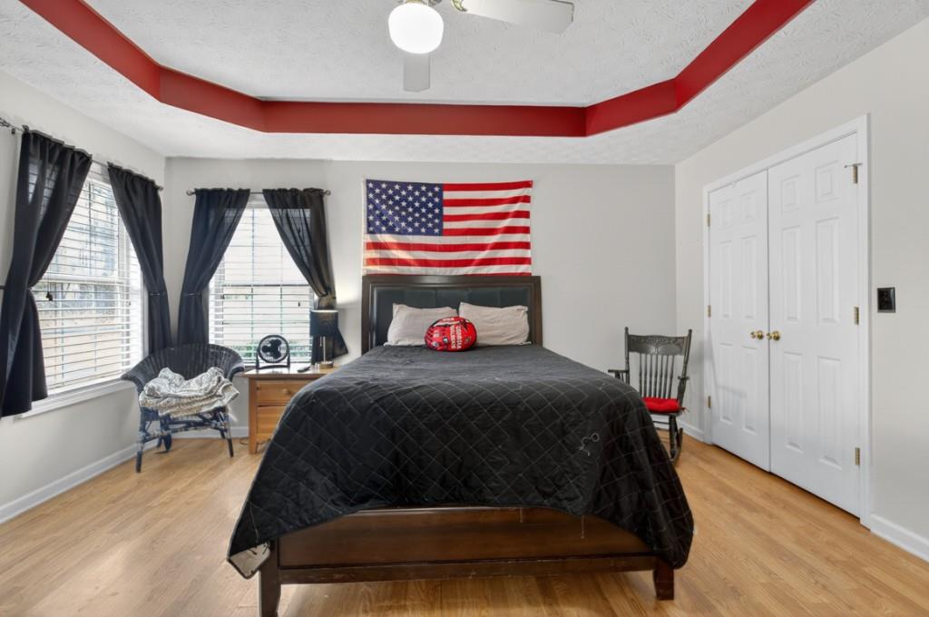 701 Muirfield Drive Winder, GA 30680 - Photo 26 of 35 a bedroom with a bed and wooden floor