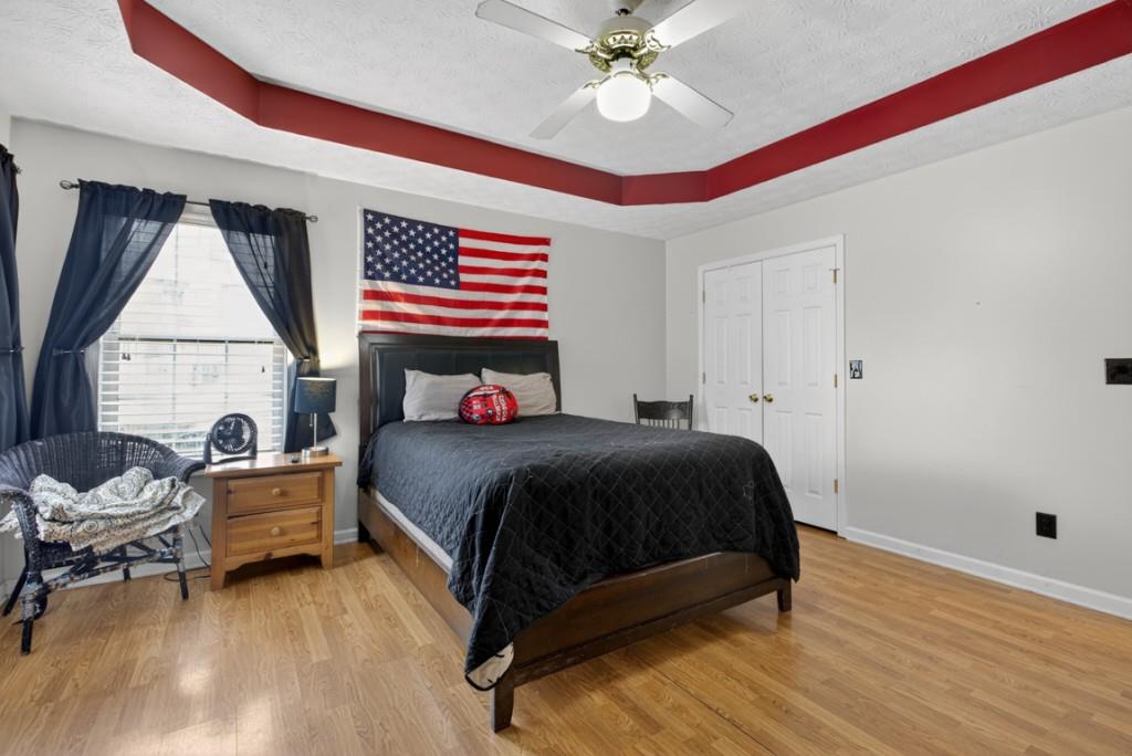 701 Muirfield Drive Winder, GA 30680 - Photo 27 of 35 a bedroom with a bed and a chandelier