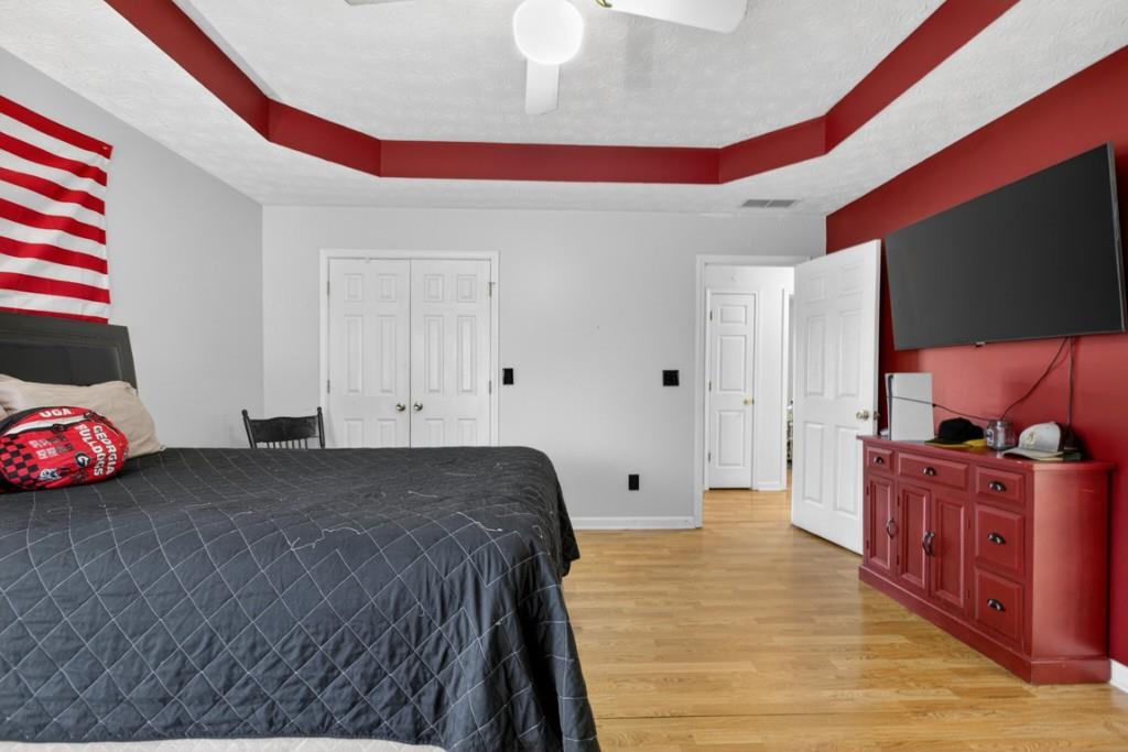 701 Muirfield Drive Winder, GA 30680 - Photo 28 of 35 a bedroom with a bed and a flat screen tv