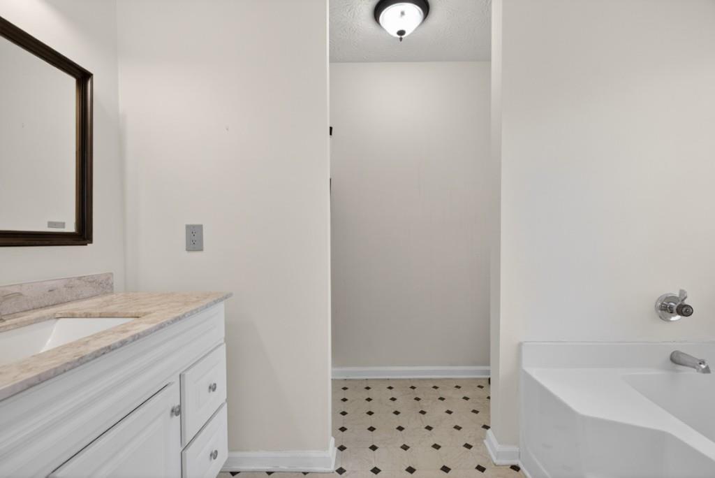 701 Muirfield Drive Winder, GA 30680 - Photo 29 of 35 a bathroom with a sink a vanity and a mirror