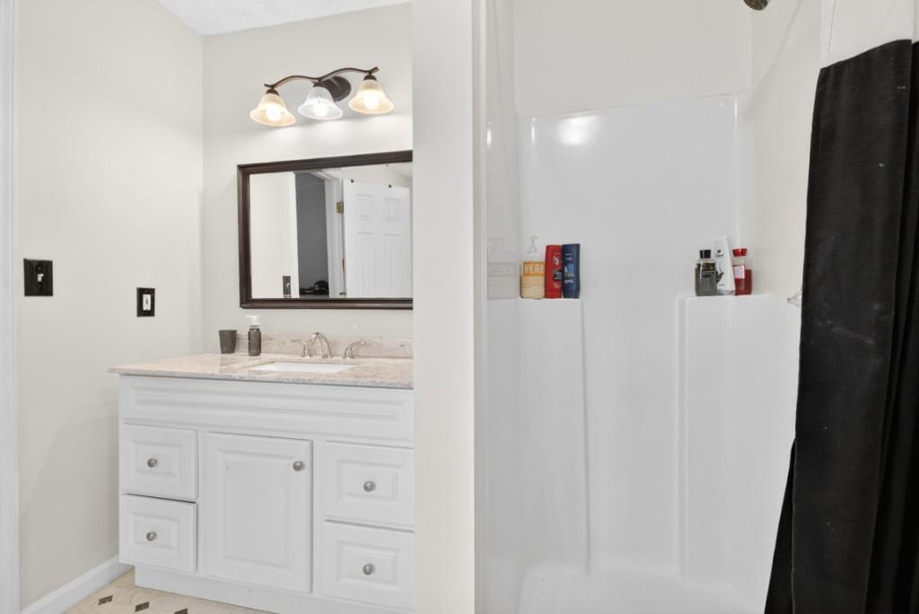 701 Muirfield Drive Winder, GA 30680 - Photo 30 of 35 a bathroom with mirror a sink and a mirror