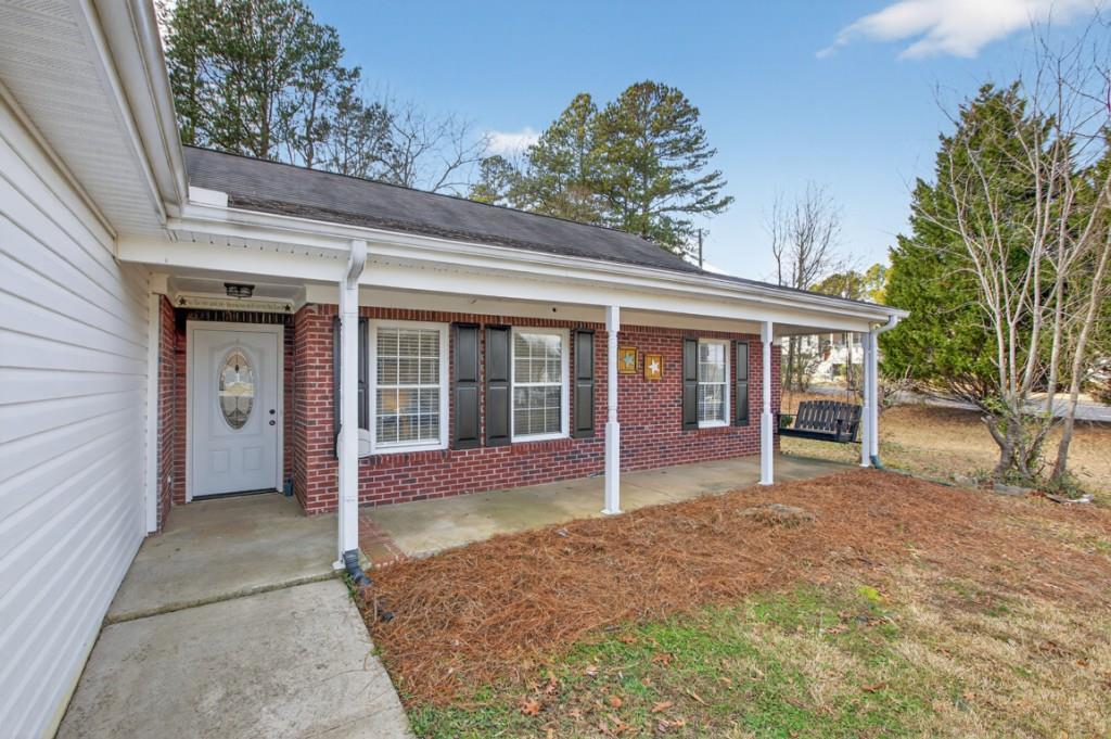 701 Muirfield Drive Winder, GA 30680 - Photo 3 of 35 a front view of a house with a garden and entryway