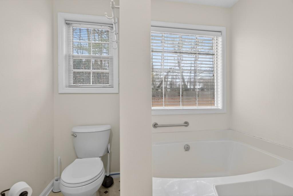 701 Muirfield Drive Winder, GA 30680 - Photo 31 of 35 a white toilet sitting next to a window