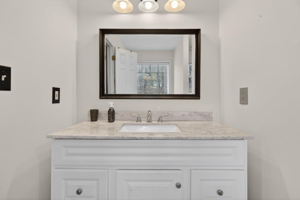 701 Muirfield Drive Winder, GA 30680 - Photo 32 of 35 a bathroom with a sink vanity and a mirror