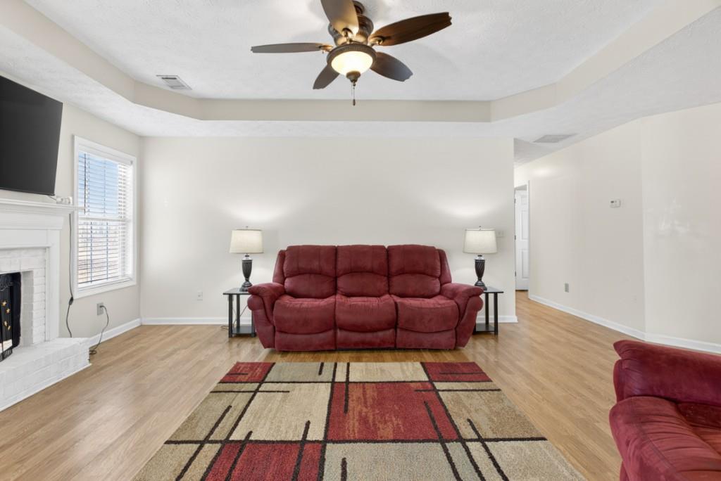 701 Muirfield Drive Winder, GA 30680 - Photo 6 of 35 a living room with furniture and a fireplace