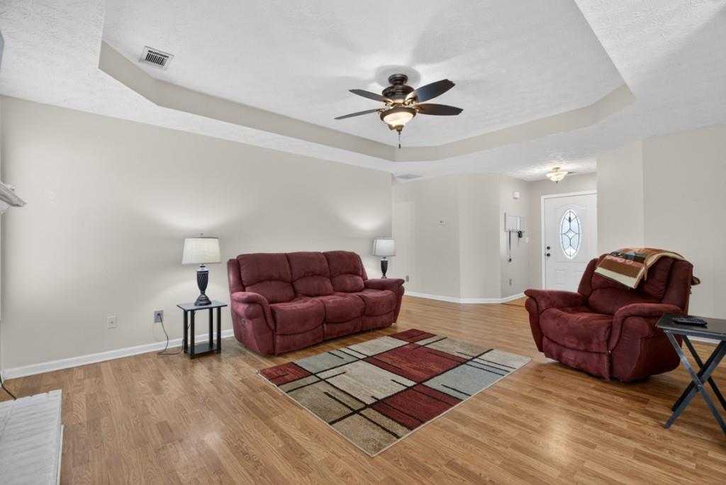 701 Muirfield Drive Winder, GA 30680 - Photo 7 of 35 a living room with furniture and a wooden floor