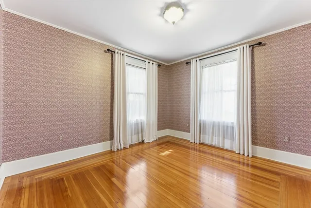 a view of a room with wooden floor