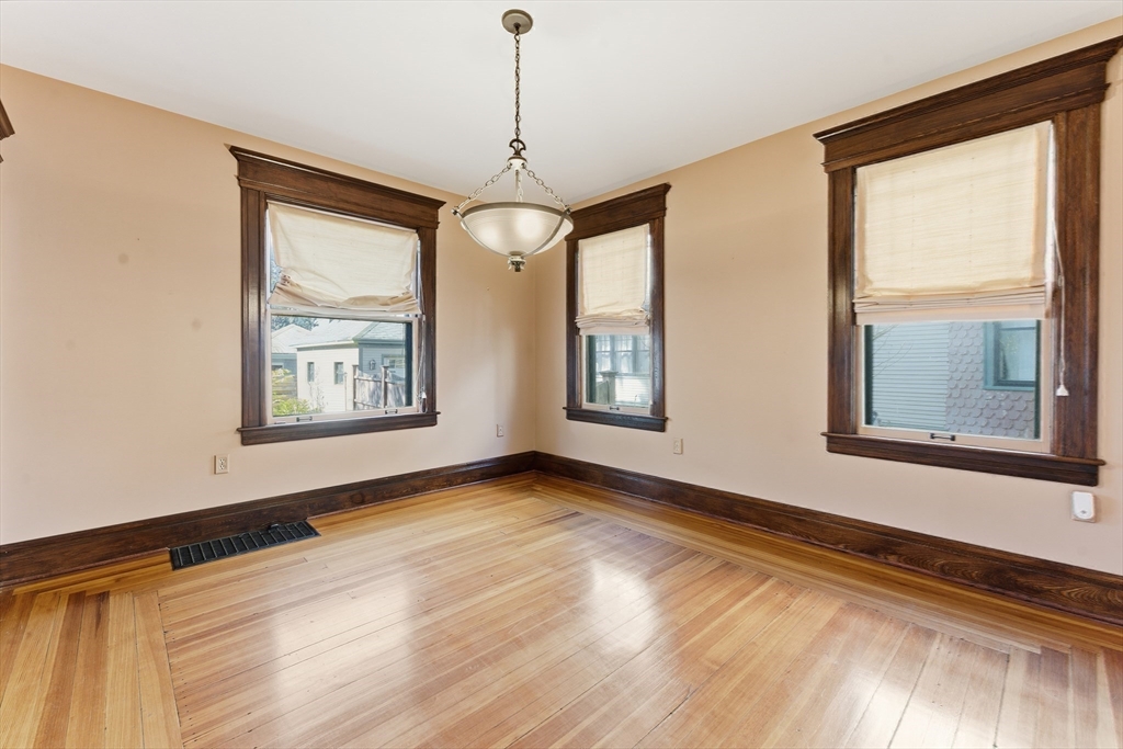 106 Magnolia Terrace Springfield, MA 01108 - Photo 23 of 42 a view of an empty room with a window and wooden floor