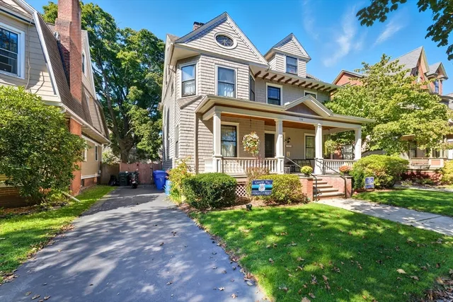 a front view of a house with garden and porch