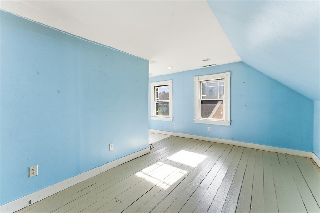 106 Magnolia Terrace Springfield, MA 01108 - Photo 36 of 42 an empty room with wooden floor and windows