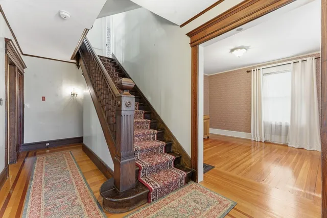 a view of entryway and hall with wooden floor