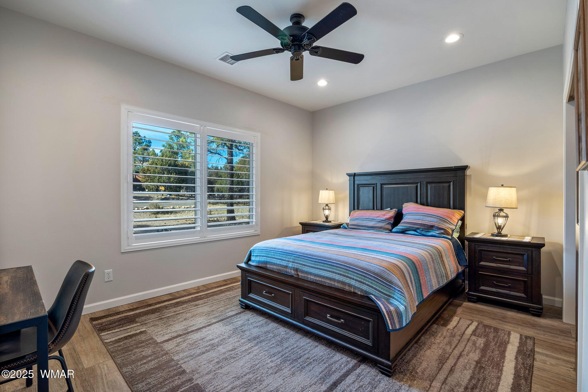 2841 Lodgepole Road Overgaard, AZ 85933 - Photo 21 of 44 a bedroom with a bed a table and chair