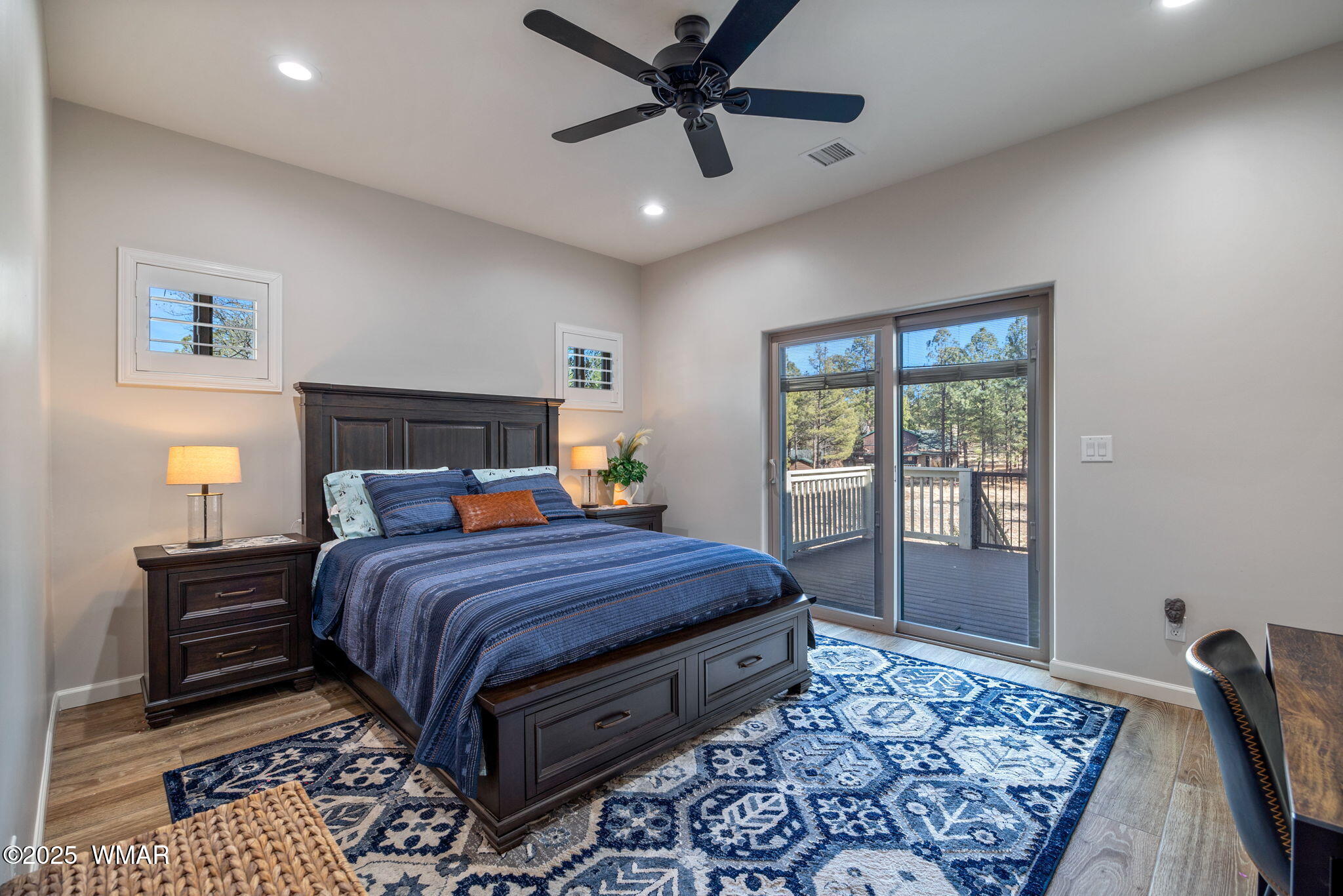 2841 Lodgepole Road Overgaard, AZ 85933 - Photo 24 of 44 a bedroom with a large bed and a chandelier