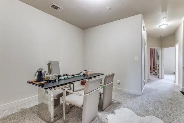 a room with a table chairs and wooden floor