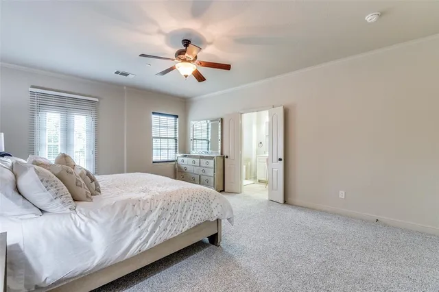 a bedroom with a large bed chandelier and a window