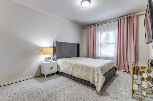 a spacious bedroom with a bed and a lamp