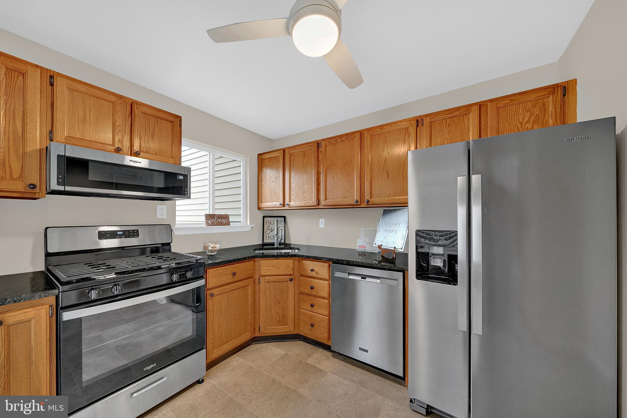 335 Silvia Street Ewing, NJ 08628 - Photo 1 of 25 a kitchen with stainless steel appliances granite countertop a refrigerator stove top oven a sink and dishwasher
