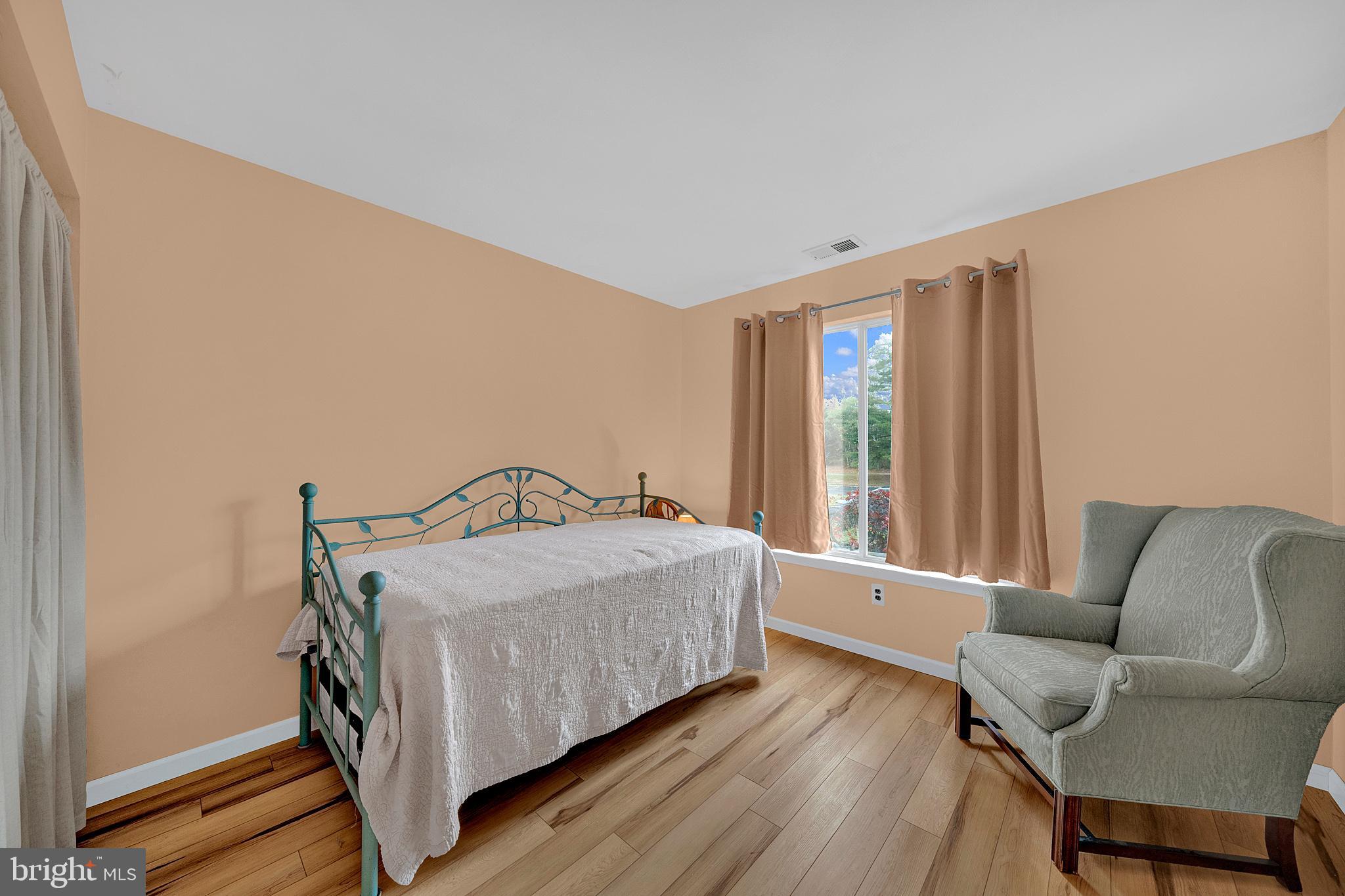 335 Silvia Street Ewing, NJ 08628 - Photo 13 of 25 a bedroom with a bed couch and a window