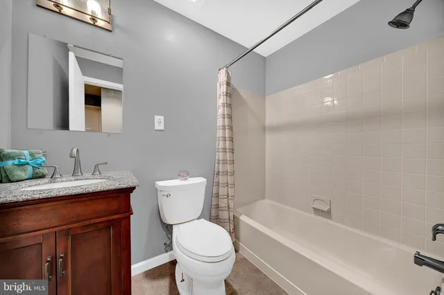 a bathroom with a toilet a sink and a mirror