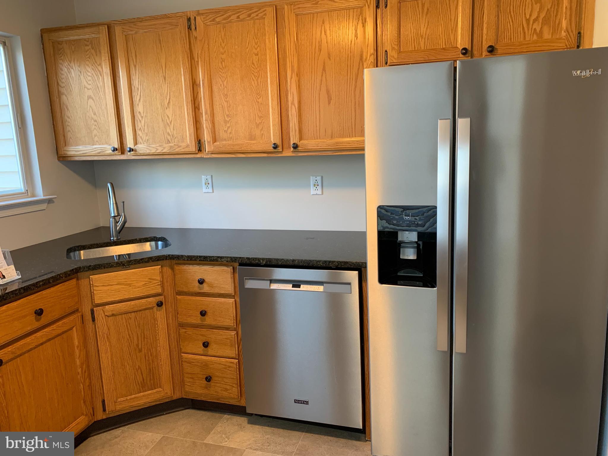 335 Silvia Street Ewing, NJ 08628 - Photo 6 of 25 a kitchen with stainless steel appliances granite countertop a refrigerator and a stove