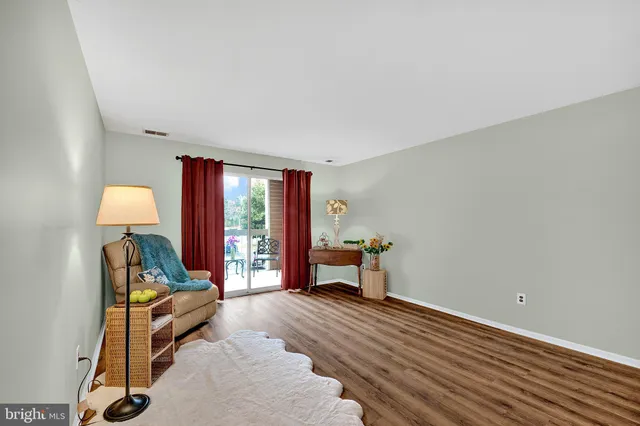 a workspace room with wooden floor and furniture