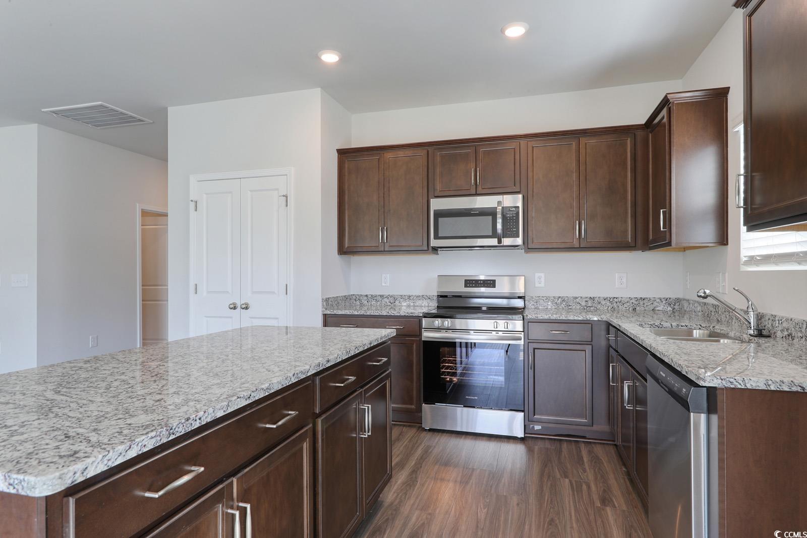 703 St Albans Loop Conway, SC 29526 - Photo 8 of 24 Kitchen with dark wood-style flooring, light stone