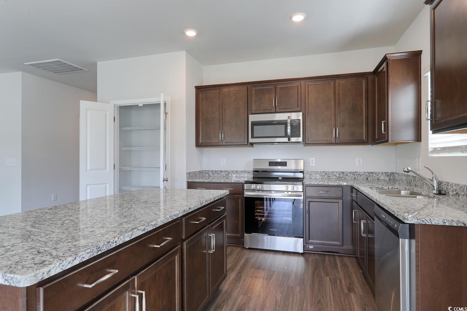 703 St Albans Loop Conway, SC 29526 - Photo 9 of 24 Kitchen with light stone counters, dark wood-type
