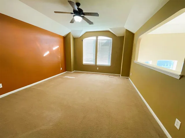 a view of room with window and ceiling fan