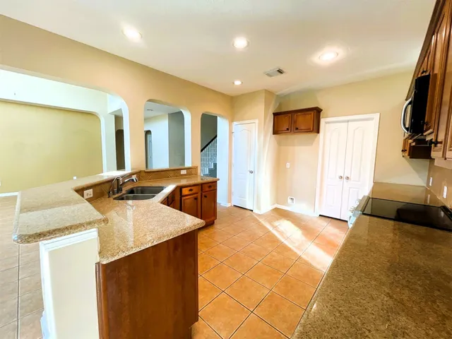 a kitchen with a sink and a refrigerator