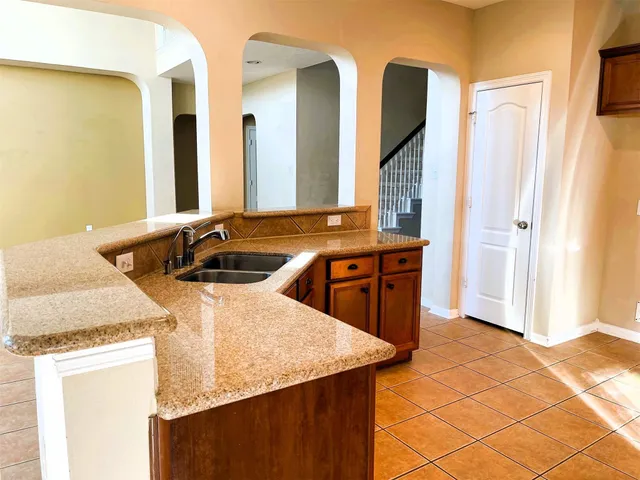 a kitchen with stainless steel appliances granite countertop sink stove and cabinets