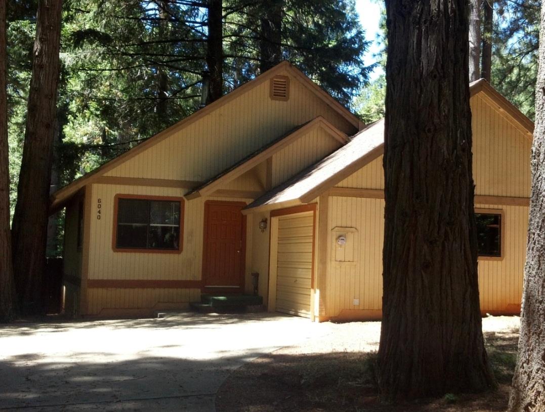 a view of house with yard