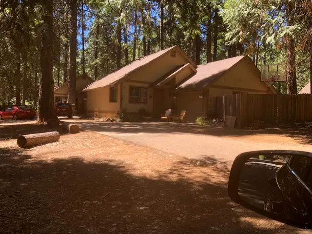 a view of a house with a yard covered in snow