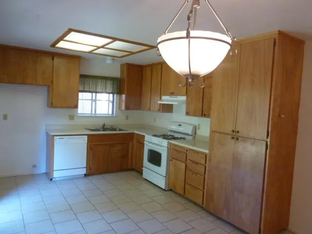 a kitchen with a sink cabinets and window