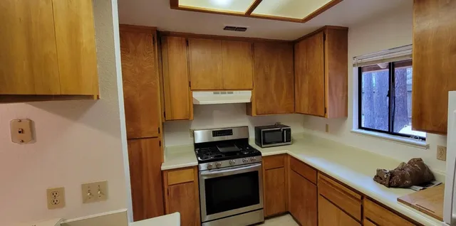 a kitchen with a stove and a microwave