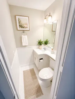 a white toilet sitting next to a bathroom sink