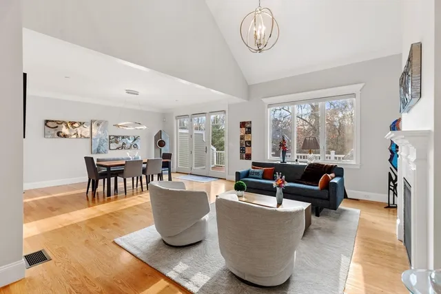 a living room with furniture a fireplace and a large window