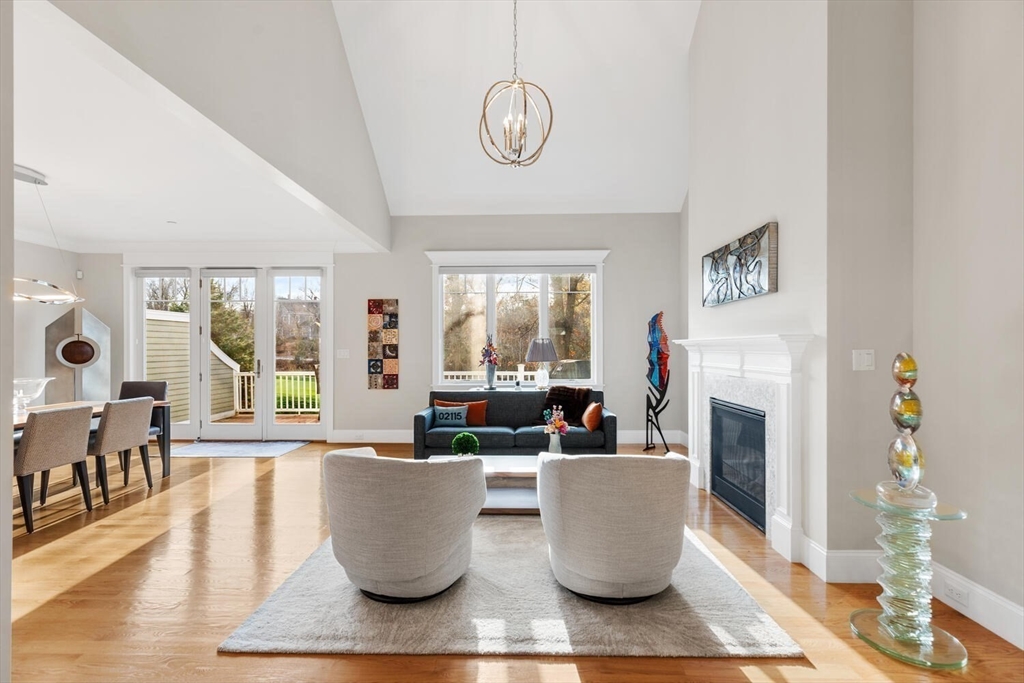 37 Crenshaw Lane, Unit 37 Andover, MA 01810 - Photo 17 of 40 a living room with furniture a fireplace and a large window